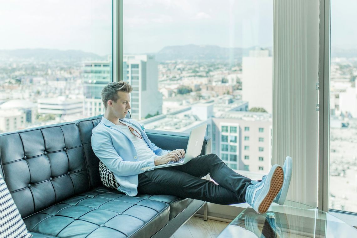 This is Going to Be a Revolution You’ll Book a Doctor’s Appointment Online man sitting on sofa while using laptop