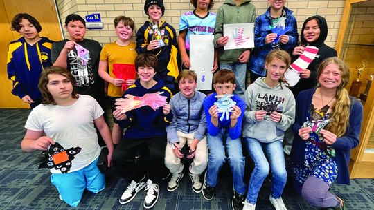 Northport Public School Art Teacher Jen Evans is pictured with students from the sixth grade class and their hand turkey creations. Photo courtesy of Jen Evans