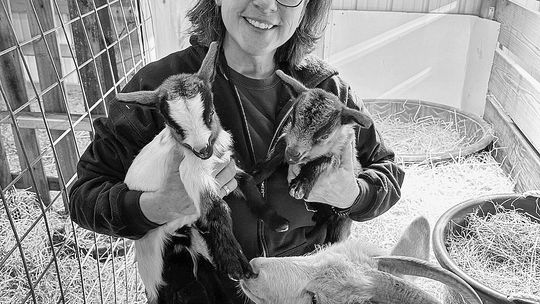 Linda Oosse is pictured with “Princess” the goat and her babies at the barn. Courtesy photo