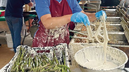 Grass-dippin’ at the Asparagus Festival. Workers from Art’s Tavern hustle to keep up with the asparagus lovers at the 21st Annual Asparagus Festival in Empire. Photo courtesy of Cindy Waldeck