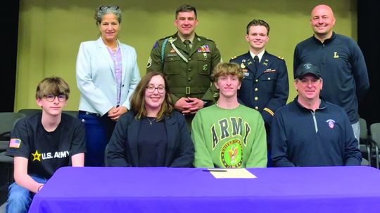 Jimmy Alpi signs to the Army with his dad, mother, and brother look on. Local Army Sergeant Michael Thorton and his captain were in attendance. Courtesy photo