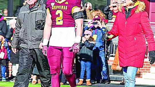 Nick Apsey walks out with his parents Traci Apsey and Ron Bishop on senior day in November. Courtesy photo