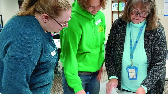 Leelanau County Clerk Michelle Crocker hands ballots off to her election workers at the government center in Suttons Bay Tuesday morning, as part of a recount for the district No. 3 commissioner race in the Nov. 5 General Election. Crocker said she expected that the recount would be comple...