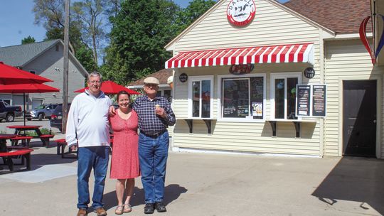 From left to right: Doug Dalzell, Haley Fox, and Alan Dalzell stand in front of the family business. Enterprise photo by Brian Freiberger