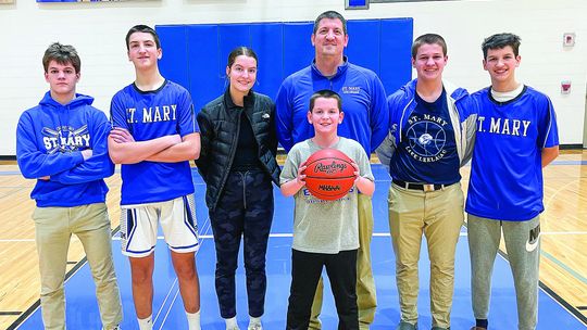 The Bunek family has kids at most ages at Lake Leelanau St. Mary. Form left to right: Rex, Josh, Della, Jim (back), Julius (front), Avery Jr., and James Bunek. Enterprise photo by Brian Freiberger