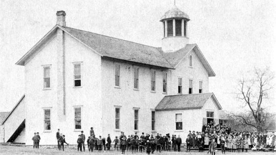 The first section of the frame school house was raised in 1865. Additions were added int 1867 and 1877. Photo from “A History of Leelanau Township.”