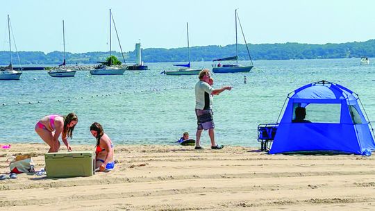 A family enjoys a day at the Greilickville Harbor Park last summer. Enterprise photo by Amy Hubbell
