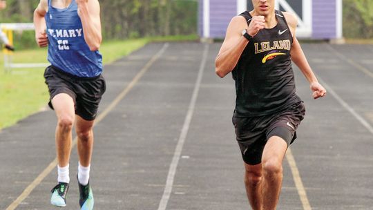 Leland senior Agustin Ceamer (right) and Lake Leelanau St. Mary sophomore Oliver Mitchell race in the 400meter run on Monday.