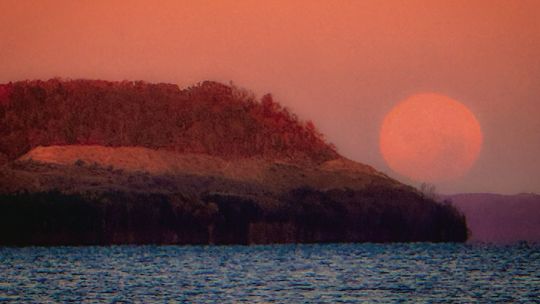 From the Good Harbor Beach access at Co. Rd. 651, the moon could be seen at its peak fullness just before setting. Photo courtesy of James Weston Schaberg