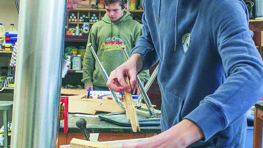 Glen Lake freshman Britton Wheeler uses the jointer to make sure the edges of the board are square.
