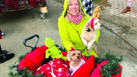 Glen Arbor resident Michele Aucello smiles with her puppies during a Black Friday bed parade last year. The bed parade will take place from 9 to 9:30 a.m. starting at the Pine Cone to Art’s Tavern. Courtesy photo