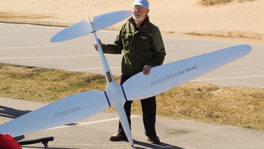 Ted Lanham shares a moment with the Little Finger Thermaleers after being gifted a model airplane he built over a decade ago to see its flight above The Dune Climb in Glen Haven on Thursday, March 7. Enterprise photo by Brian Freiberger