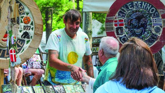 Leif Sporck of Sporck Tileart was very busy yesterday at the Glen Lake Womens Club Art Fair. Enterprise photo by Brian Freiberger