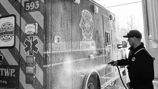 Chase Schelling, a Leland Township Fire &amp; Rescue lieutenant and EMS Coordinator, gives a customized ambulance a wash for the first time. Courtesy photo