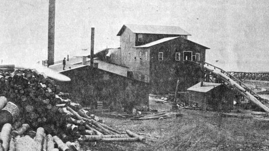 The second Empire Mill with tramway to right, power slide with endless chain for hauling logs into the mill. Photo courtesy of the Empire Area Heritage Group