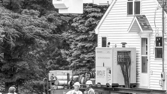 Construction and utility workers coordinated the moving on July 2 of a home owned by the late Theresa Schaub down the street . It is now owned by “Miss Schaub’s” great niece, and remains on the original Jacob Schaub homestead property located south of Lake Leelanau. Photo courtesy of Deb C...