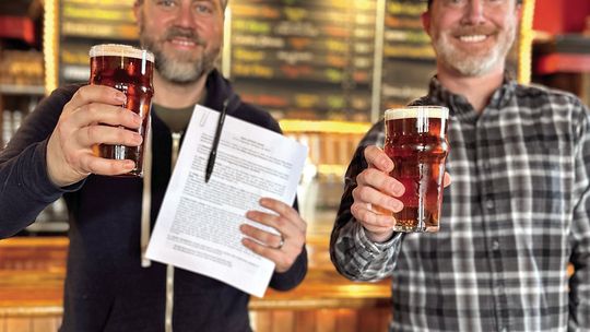 The Mitten Brewing Company owners Chris Andrus (at left) and Max Trierweiler (right) are pictured at their Northport location on Tuesday after securing a long-term lease with Three Rivers Properties. The five year lease with a five year renewal term helps ensure that The Mitten’s “up north...
