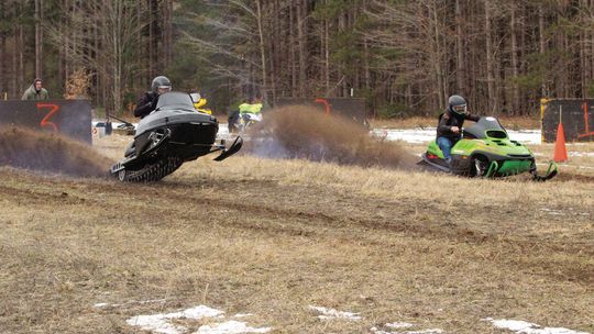 No snow, no problem! The Roy Taghon Empire Snowmobile Drag Race went off without snow as dozens of sled heads from around northern Michigan participated in the race that raises money for Glen Lake scholarships. Two racers dash off the starting line, spewing dirt and exhaust in front of spe...