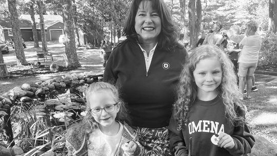 Susie Morrison and her twin granddaughters, Eleanor and Johanna Tock, from Holland, Michigan, enjoyed the Omena Bridge Walk and the Rubber Duck Race which followed. Johanna is now the two-winner of the Duck Race. Photo courtesy of Susie Morrison
