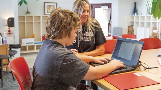 Teacher Michelle Couturier helps a student with an assignment. Courtesy photo