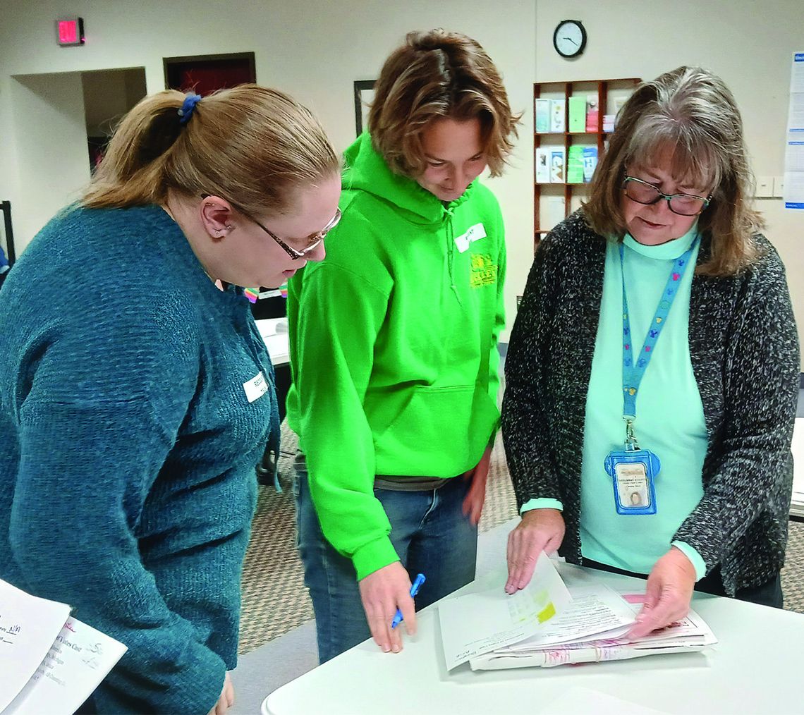 Leelanau County Clerk Michelle Crocker hands ballots off to her election workers at the government center in Suttons Bay Tuesday morning, as part of a recount for the district No. 3 commissioner race in the Nov. 5 General Election. Crocker said she expected that the recount would be comple...