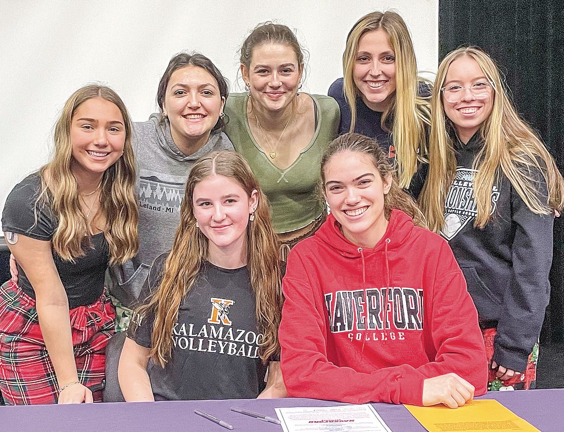 Leland seniors Olive Ryder (center-left) and Fiona Moord (center-right) are joined by their Comet teammates as they committed to play volleyball at the collegiate level. Enterprise photo by Brian Freiberger