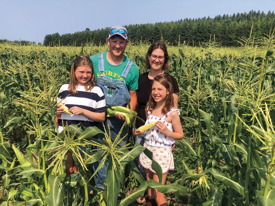 Curtis and Melissa Kelenske get help from their daughters, Sasha, 11, and Sienna, 7, picking sweet corn from their family farm in Centerville Township. See story Pg. 8 Enterprise photo by Alan Campbell