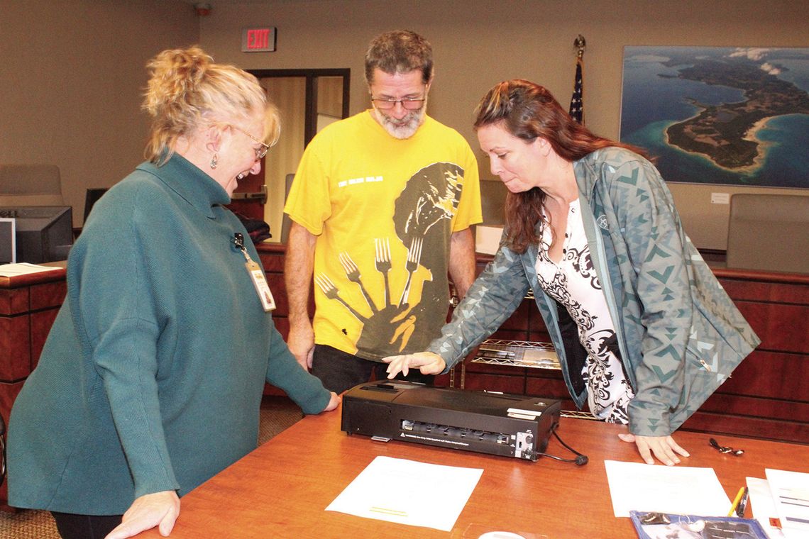 Leelanau County Deputy Clerk Lynndell Drzewiecki and Kasson Township Shiree Nelson and Jon Hurst count early voting ballots Tuesday night at the Government Center in Lake Leelanau. Enterprise photo by Brian Freiberger