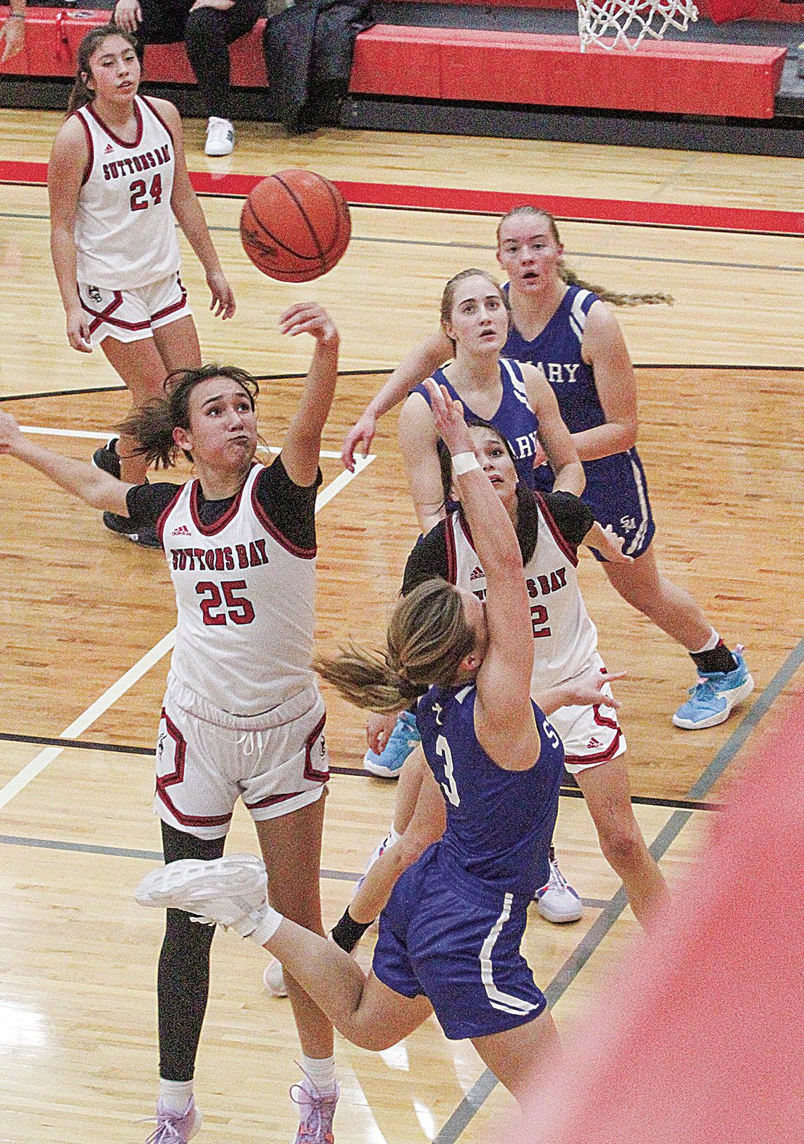Suttons Bay senior Keeley TwoCrow blocks St. Mary’s Cathryn Mikowski as she drives to the basket.