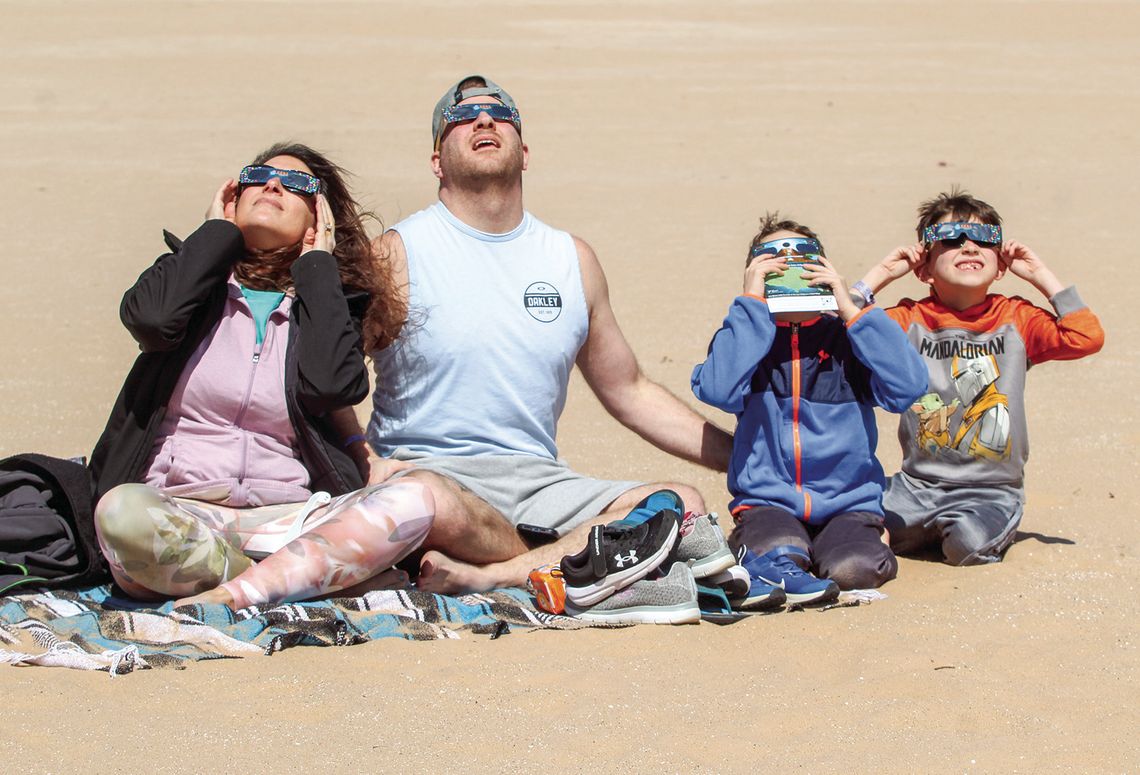 The McGeathe family enjoy the solar eclipse from the Dune Climb within the Sleeping Bear Dunes National Lakeshore on Monday, April 8. The eclipse occasion brought hundreds of people to the Dune Climb to enjoy the once-in-a-lifetime event. From left to right: Tracy, Dave, Lance, Hunter. Ent...