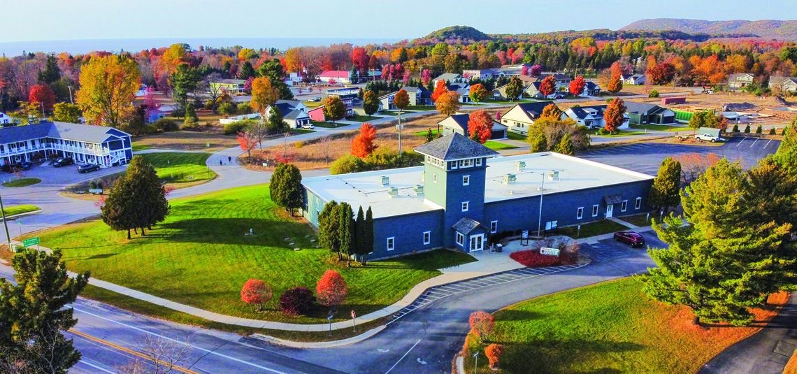 Empire sits on the shores of Lake Michigan in peak fall color earlier this week. The Sleeping Bear Dunes National Lakeshore Philip A. Hart Visitor Center is pictured in front. Enterprise photo by Brian Freiberger (FAA Part-107 Drone license)