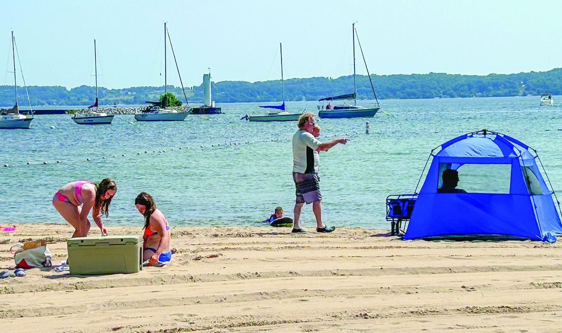 A family enjoys a day at the Greilickville Harbor Park last summer. Enterprise photo by Amy Hubbell