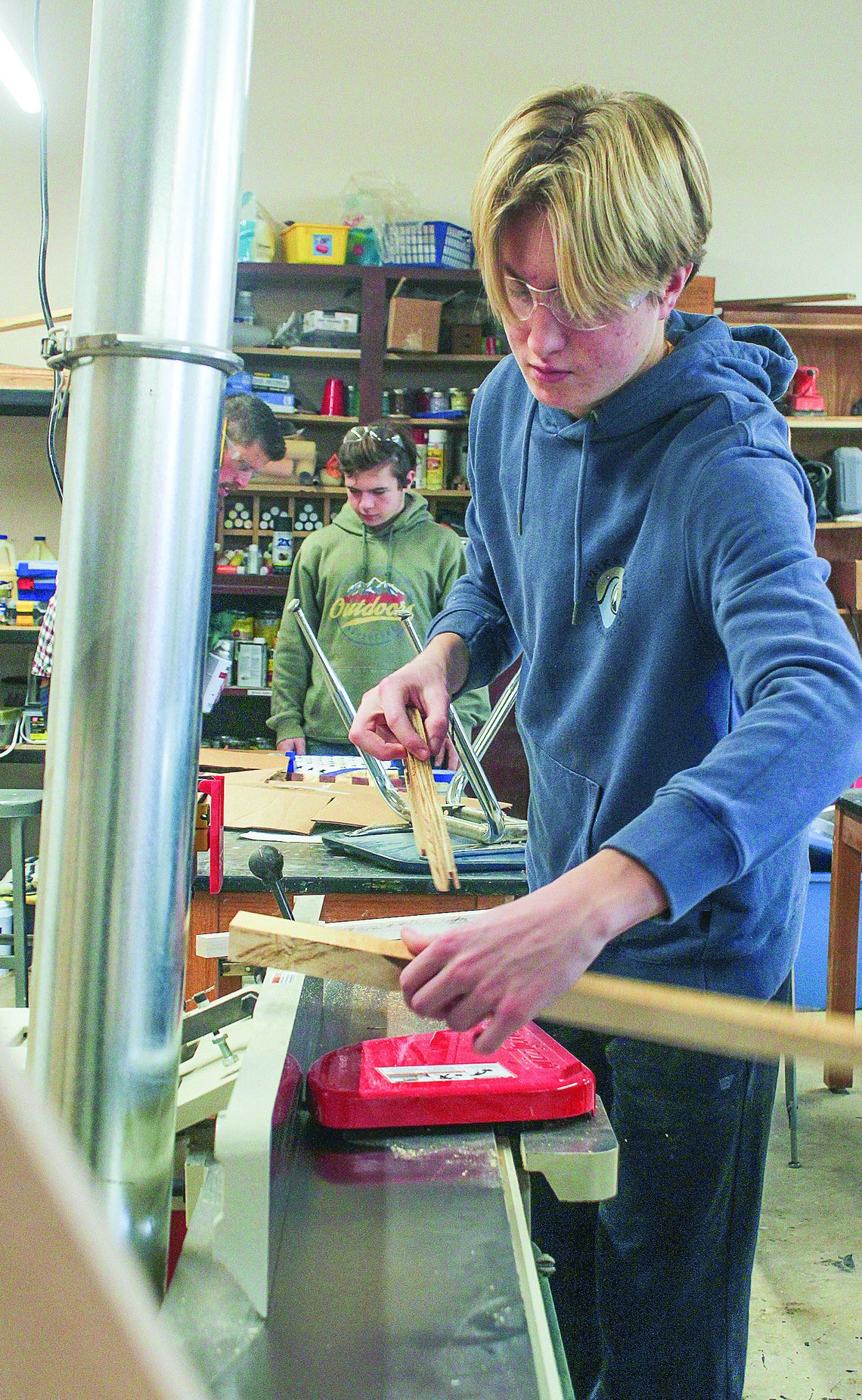 Glen Lake freshman Britton Wheeler uses the jointer to make sure the edges of the board are square.