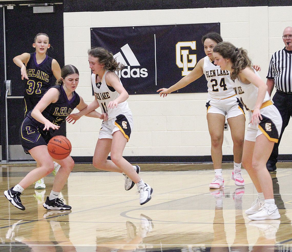 Glen Lake junior Hailey Anderson and Leland junior Elli Miller battle earlier this month in a Northwest Conference game. Both Leland and Glen Lake girls basketball have had their ups and downs, but are beginning to find their stride. Enterprise photo by Brian Freiberger