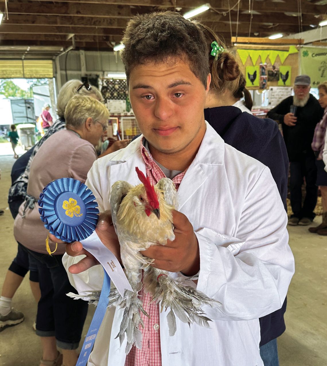 J.C. Oosse, a Lake Leelanau youth in the Michigan State University Leelanau County Extension’s 4-H Program, poses with one of his two animal projects, a bantam cock that placed first in its class at the Northwestern Michigan Fair Monday. Courtesy photo by Linda Oosse