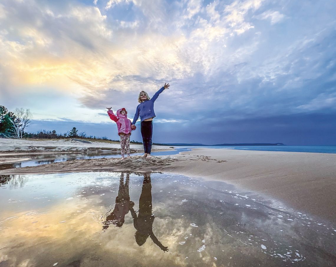 Juniper and Zinnia Schaberg, ages 8 and 3 respectively, greeted an early spring with bare feet last week at the mouth of the stream that feeds Good Harbor. Photo courtesy of James Schaberg