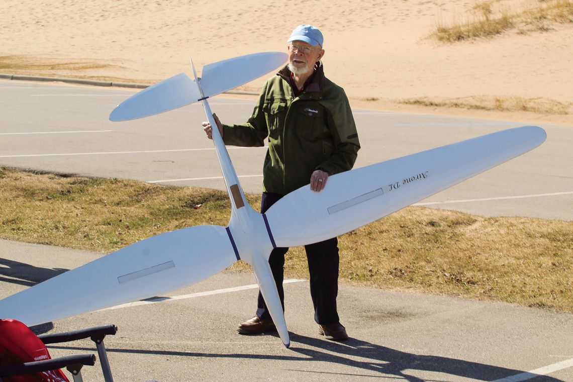 Ted Lanham shares a moment with the Little Finger Thermaleers after being gifted a model airplane he built over a decade ago to see its flight above The Dune Climb in Glen Haven on Thursday, March 7. Enterprise photo by Brian Freiberger