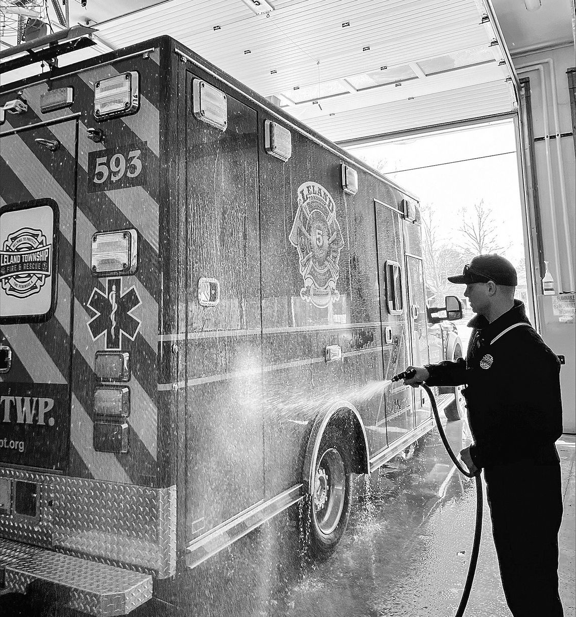 Chase Schelling, a Leland Township Fire &amp; Rescue lieutenant and EMS Coordinator, gives a customized ambulance a wash for the first time. Courtesy photo