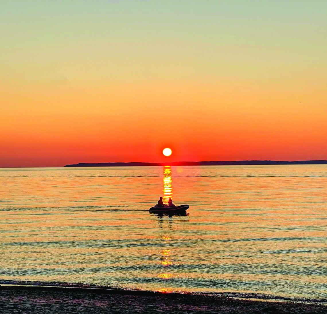 People were out enjoying the vibrant sunset setting over Lake Michigan at Van’s Beach Monday evening. Enterprise photo by Meakalia Previch-Liu