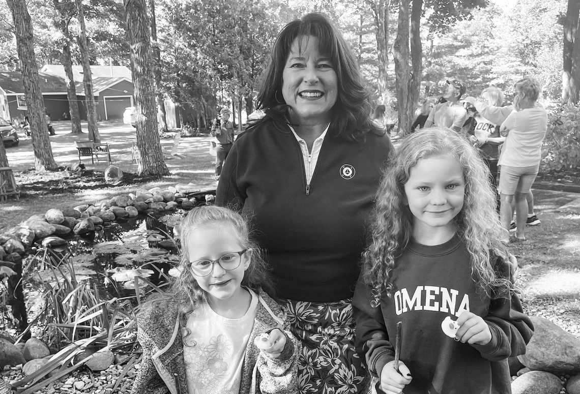 Susie Morrison and her twin granddaughters, Eleanor and Johanna Tock, from Holland, Michigan, enjoyed the Omena Bridge Walk and the Rubber Duck Race which followed. Johanna is now the two-winner of the Duck Race. Photo courtesy of Susie Morrison