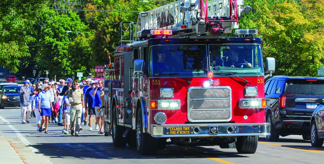 Leland bridge walkers follow a Leland Township fire truck during the LAbor Day celebrations that was followed by refreshments at the Old Art Building. Enterprise photo by Brian Freiberger