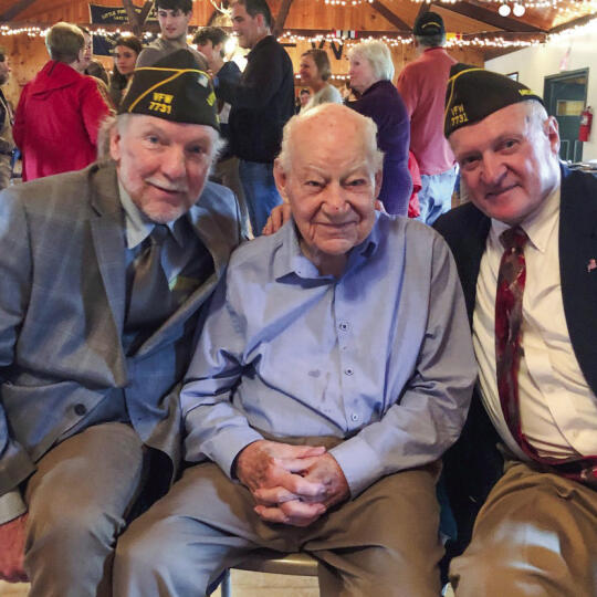 World War II and D-Day veteran Dick Grout occupied a front row seat for the Memorial Day celebration. He’s flanked by event co-directors Jim Simon and Gene Kelly. Grout is 102 years old. Enterprise photo by Alan Campbell