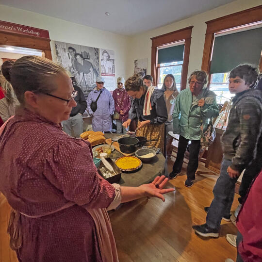 Food historian Susan Odom demonstrates what it life was like for pioneer women in the kitchen at the Olsen Farm during the Port Oneida Fair.